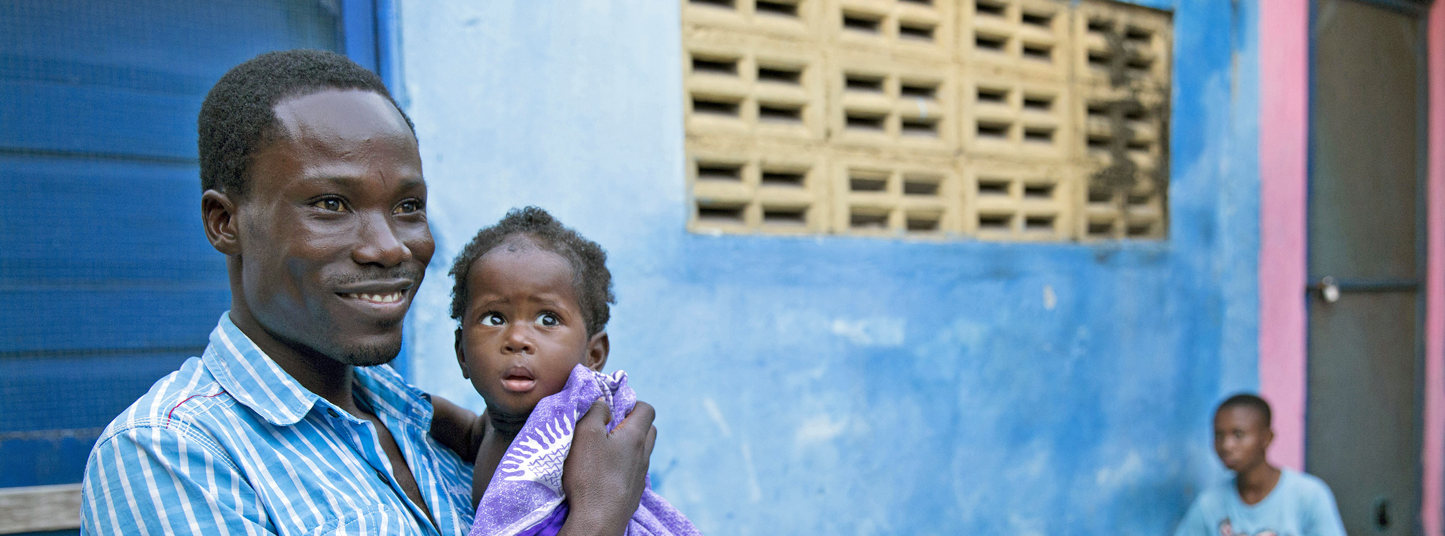 Ghana smiling father holding child