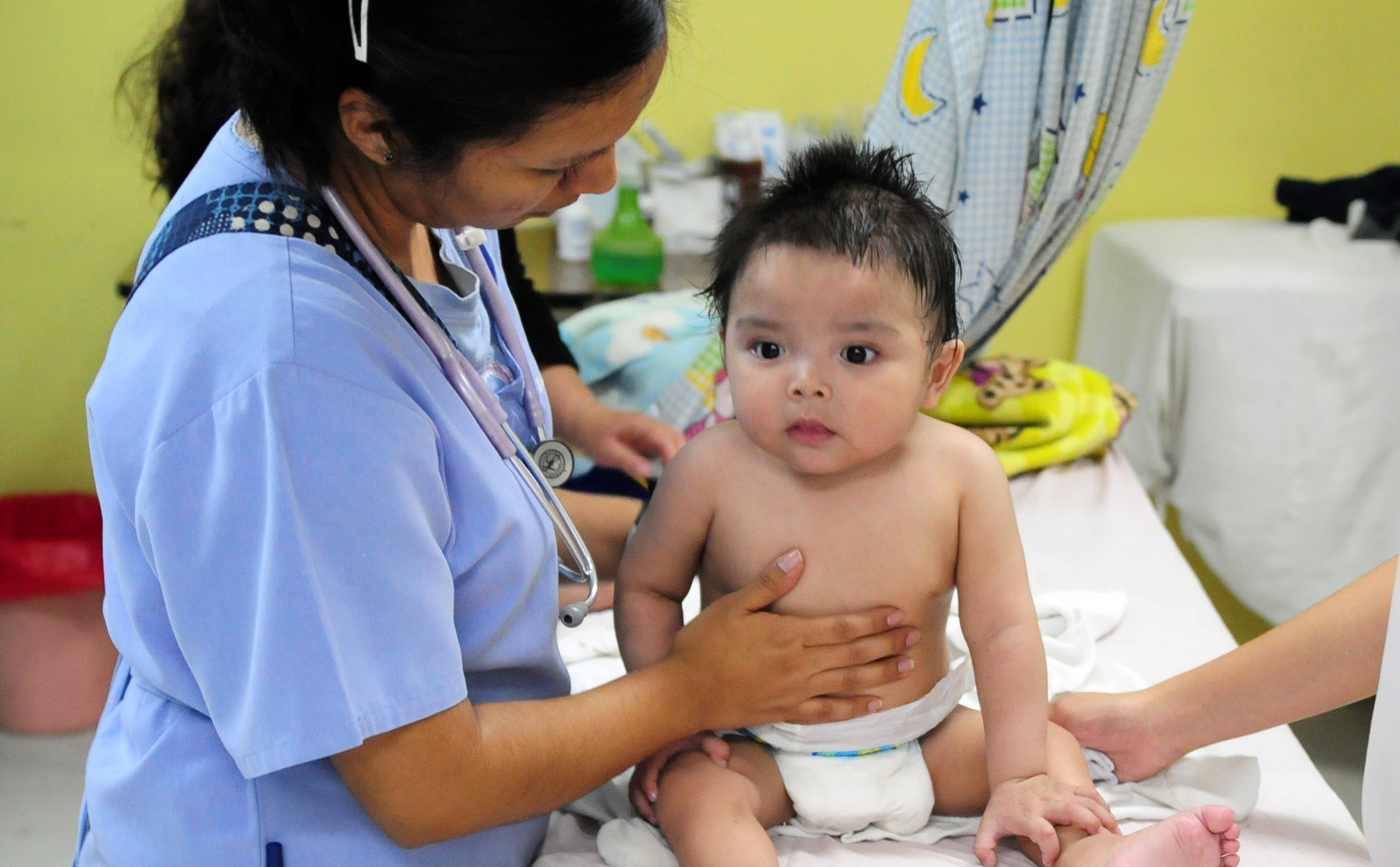 Guatemala doctor examines infant