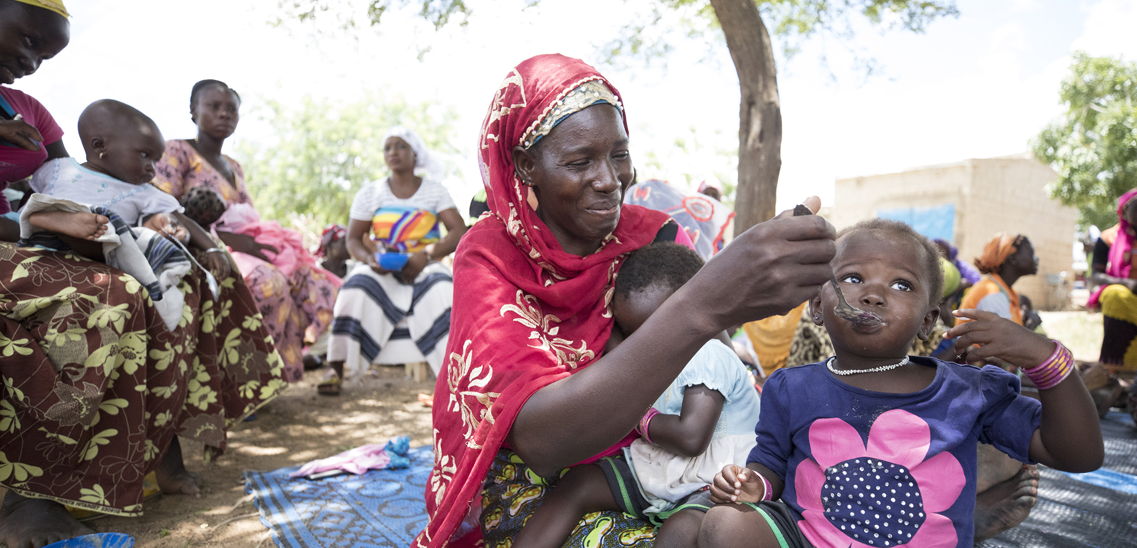 Woman feeding child