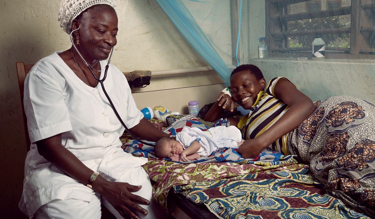 Benin nurse with a mother and a newborn. Photo: World Bank/Stephan Gladieu