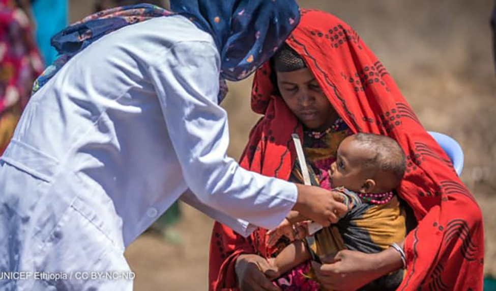 A health worker screens a child for malnutrition in Ethiopia in 2019. Photo by: UNICEF Ethiopia / CC BY-NC-ND