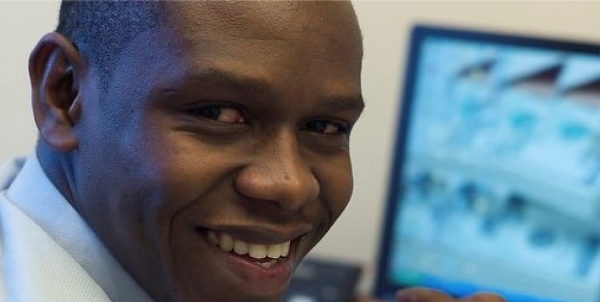 Close-up of man smiling with computer screen in the background. Photo: Anna Koblanck / IFC