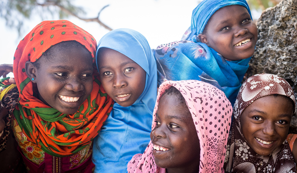 Group of African youth smile for the camera.