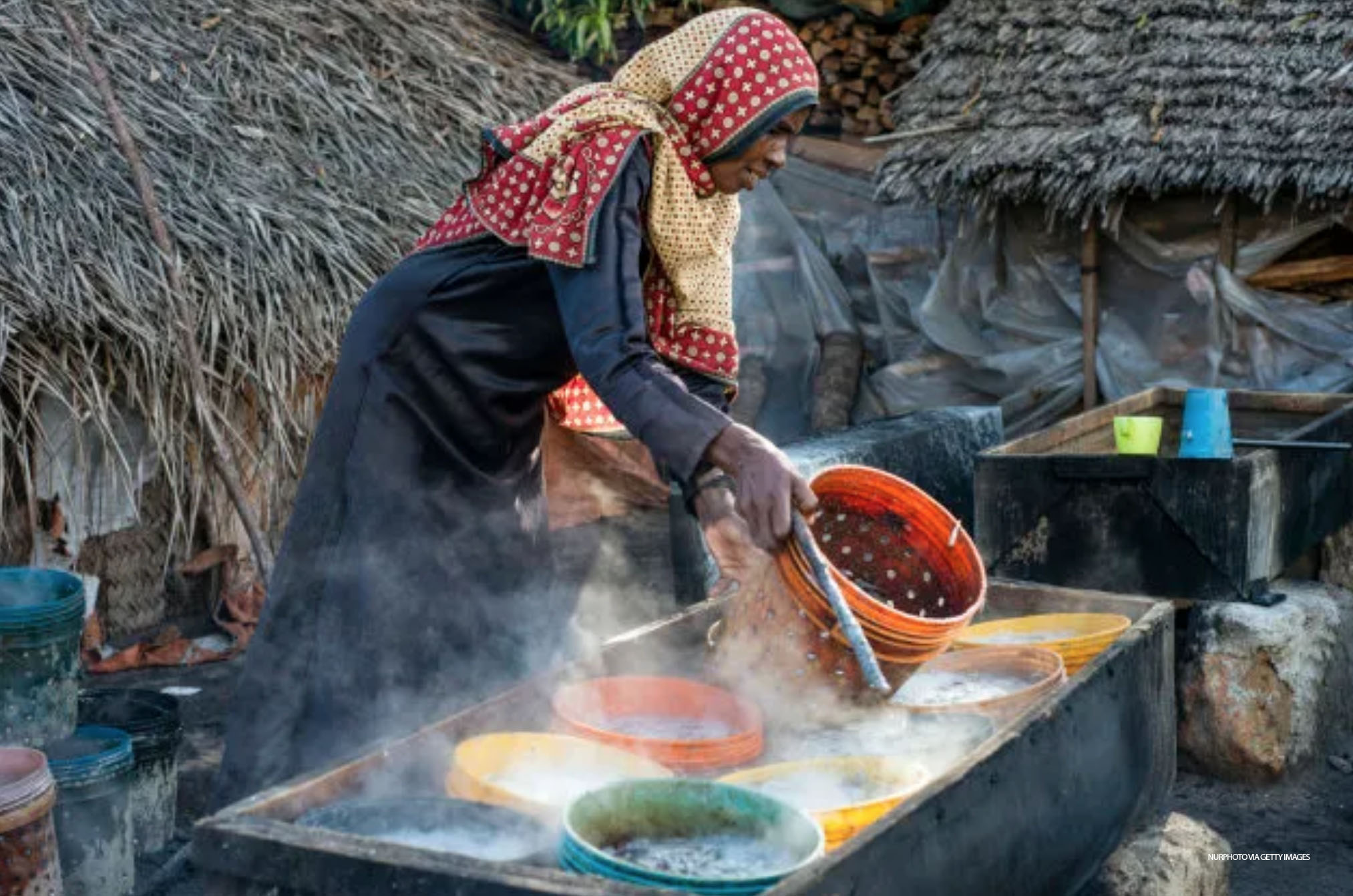 A woman prepares anchovies for drying at Mkokotoni village, Zanzibar, Tanzania - NurPhoto via Getty Images