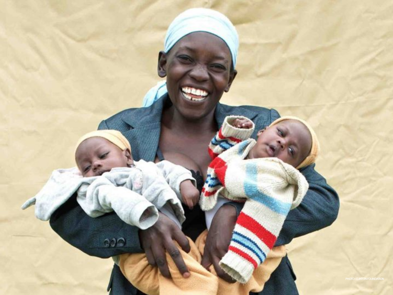 Woman holding babies - Photo: Clinton Foundation